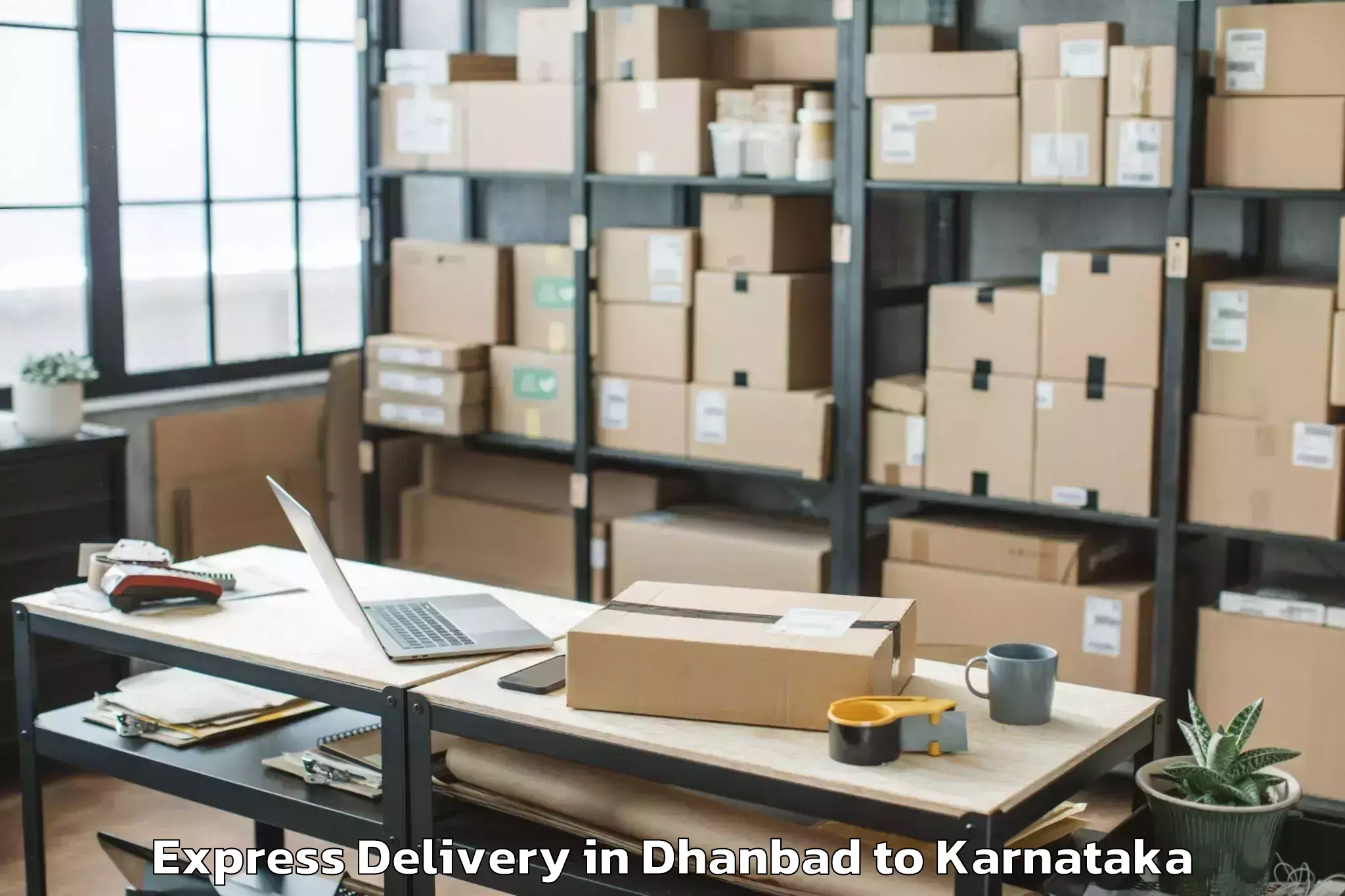 Book Dhanbad to Karnataka State Rural Developm Express Delivery Online